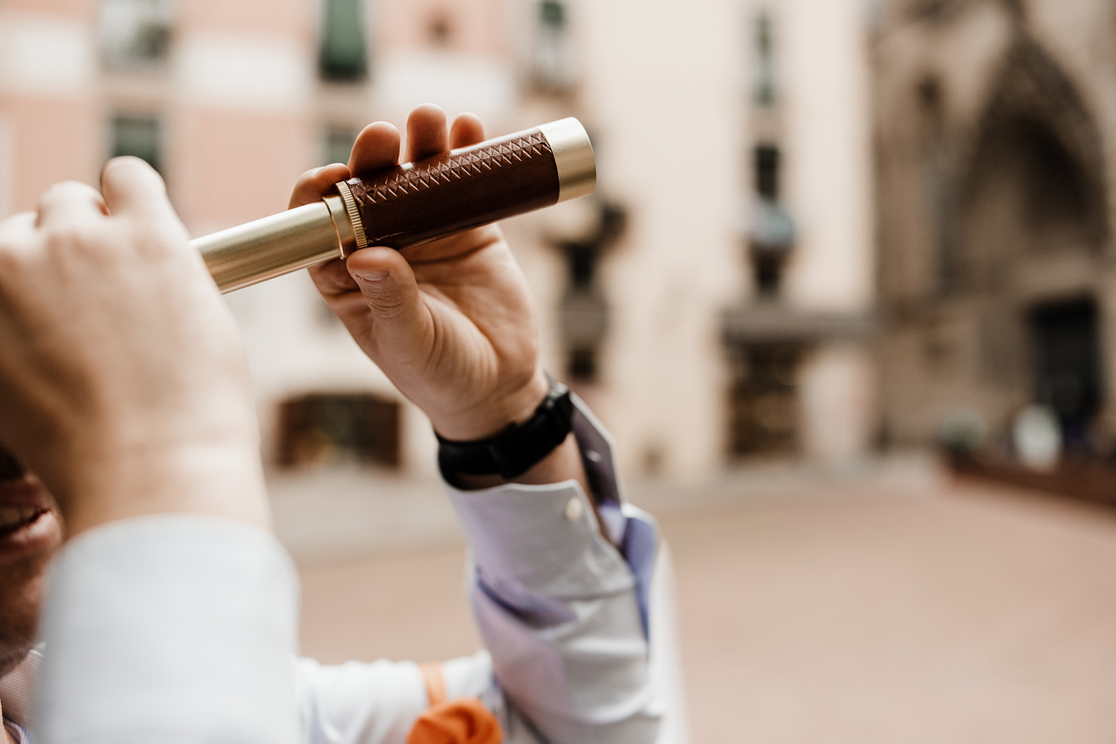 Male looking through old skool monucular. Barcelona on the background.